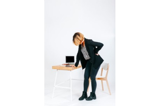image of person with back pain at work