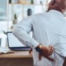 image of man at desk with back pain