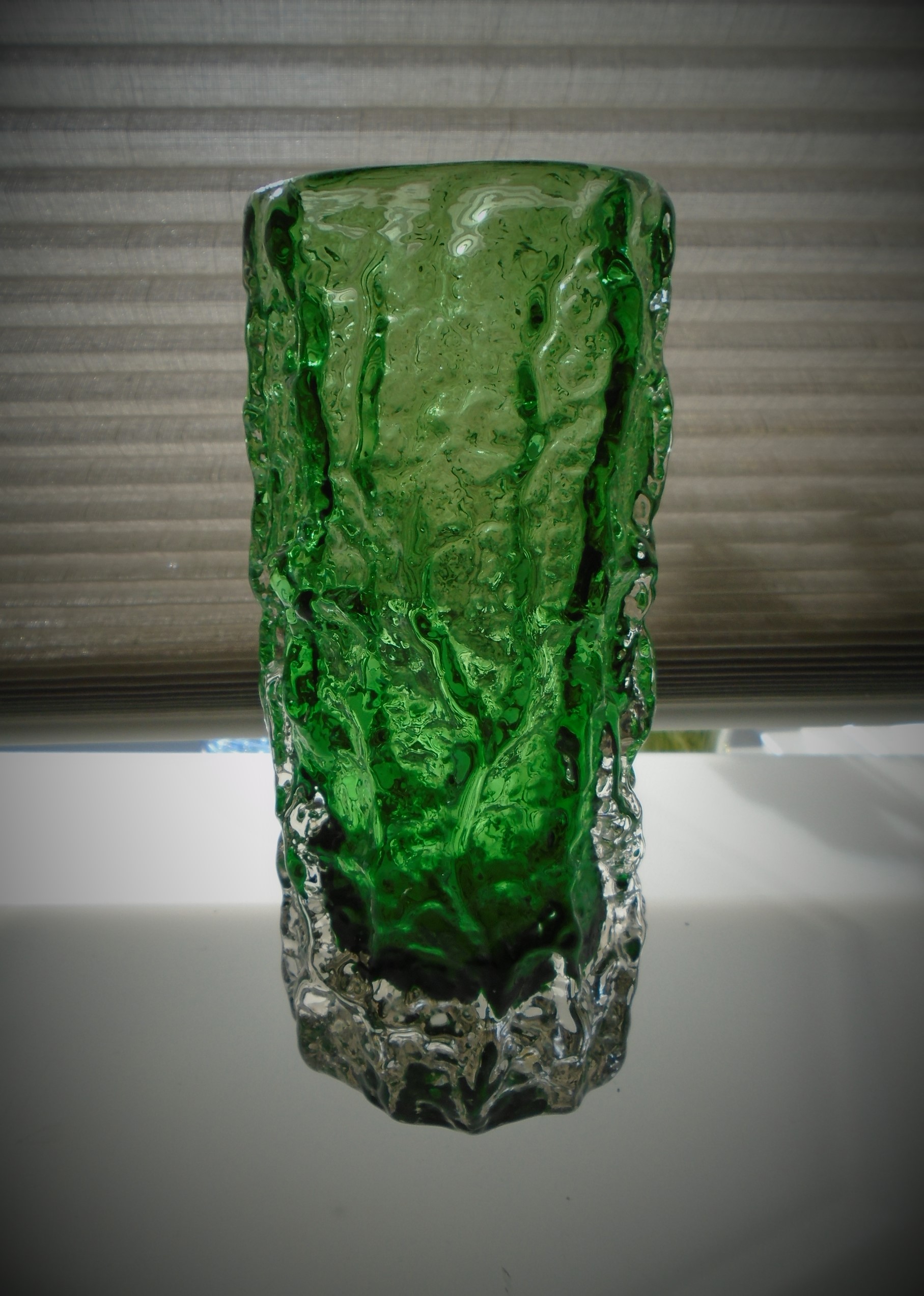 Offered for sale is an early 70s vintage Whitefriars Catalogue No. 9690 Meadow Green Bark Pattern  7.5ins high Glass Vase.
