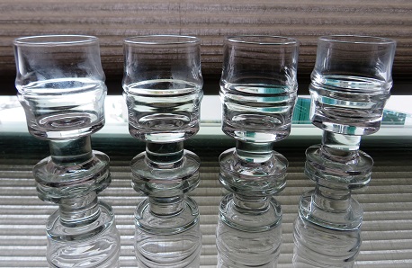 A set of 4 good condition vintage Mid 20th century Iittala Timo Sarpaneva “Pisararengas” Shot/Schnapps Glasses