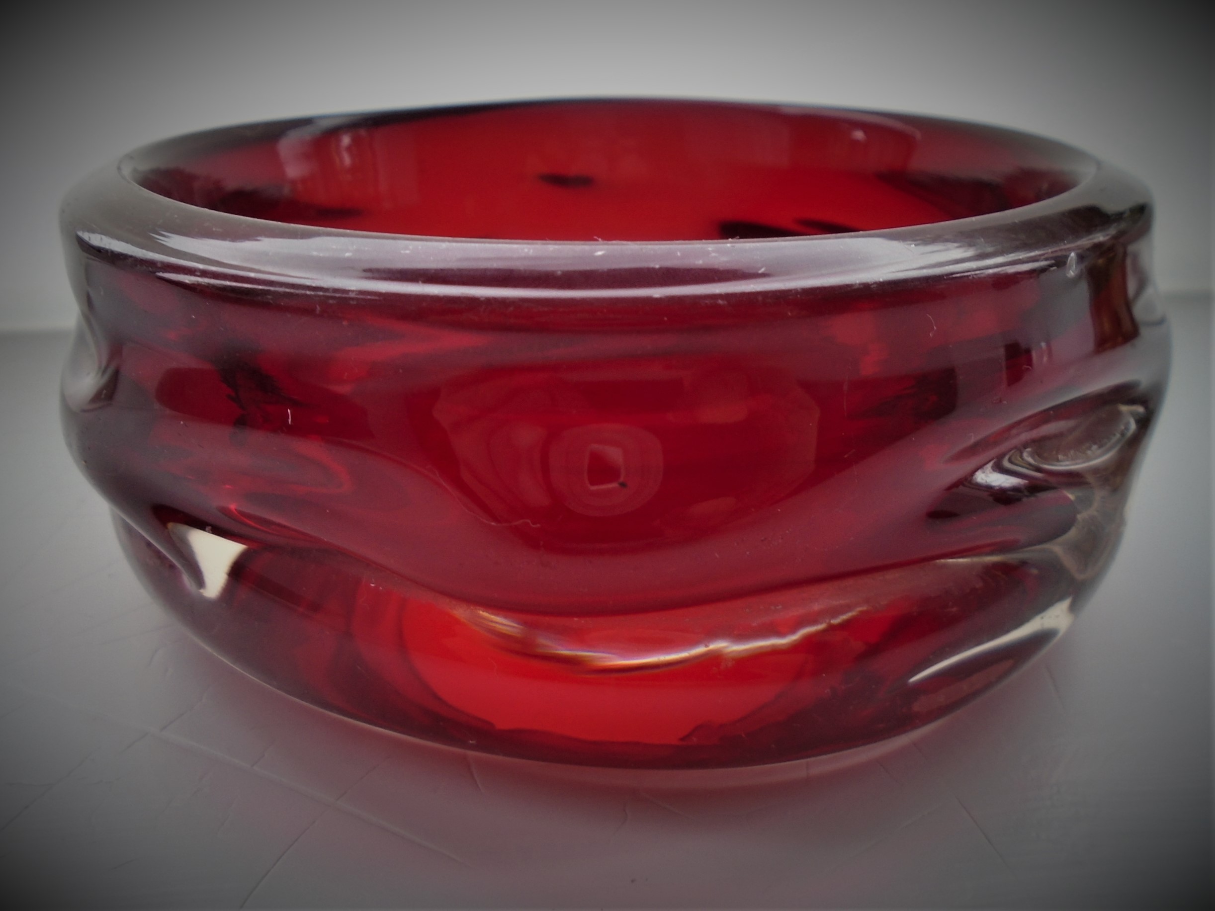 Vintage 60s Whitefriars Knobbly Ruby Glass Bowl Pattern No. 9613. It measures  14cms diameter and stands approx.5.4cms in height.