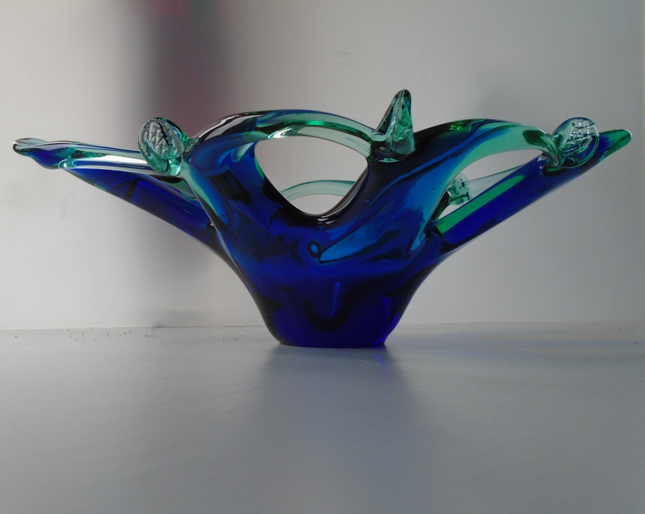 MURANO STYLE ELONGATED BOWL IN BLUE AND TURQUOISE GLASS WITH PERFORATED RIM.