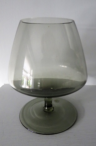 A contemporary style smokey grey brandy glass.