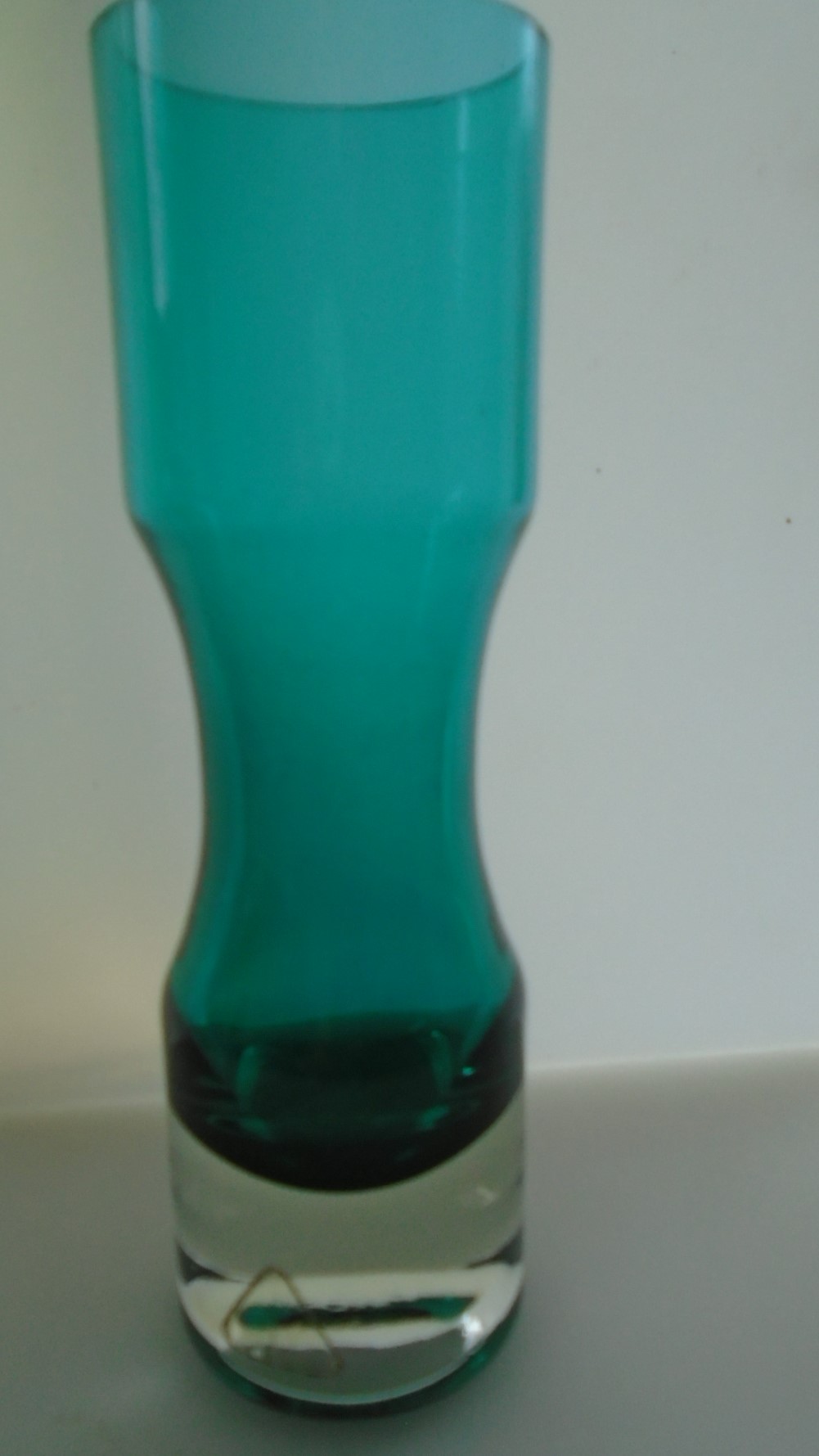 Offered for sale is an attractive less seen example of a small Riihimaki Lasi Vase in Turquoise Glass encased in clear