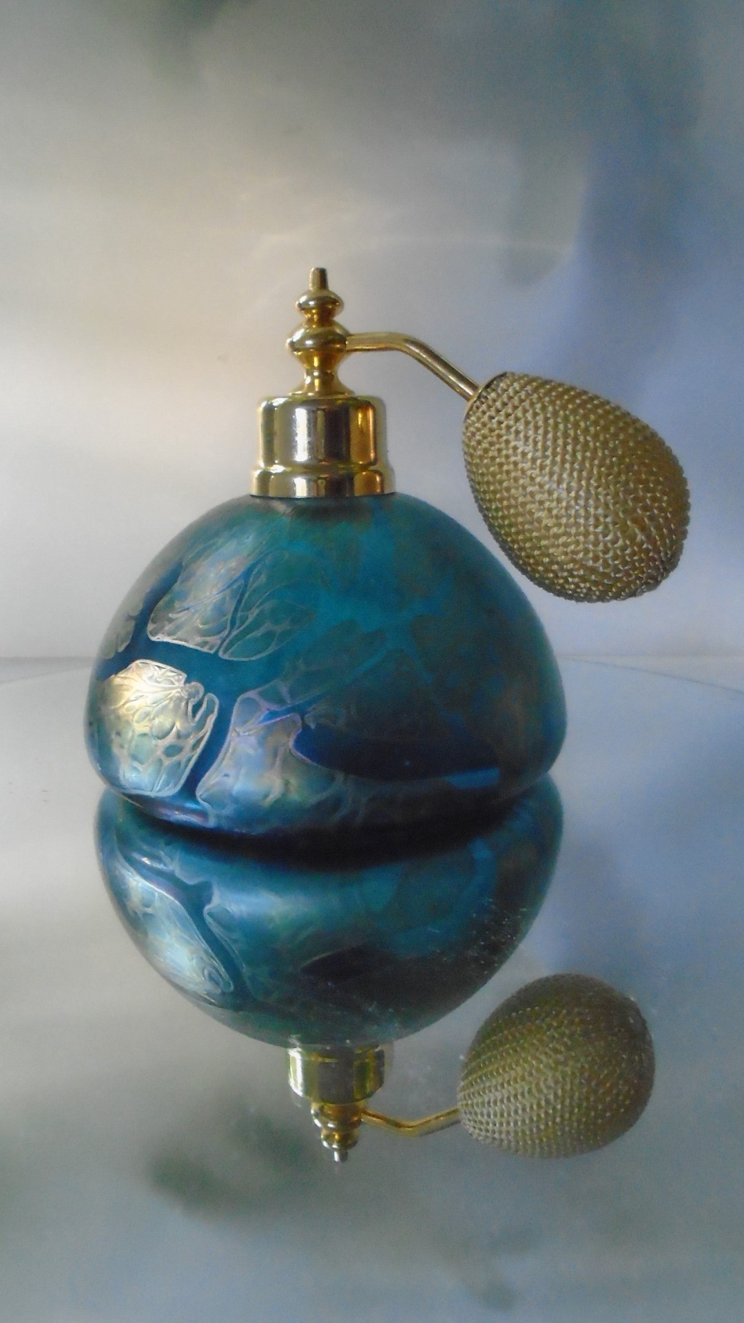 Beautiful example of a Vintage 80s Royal Brierley Studio Dome shaped Perfume Atomizer. Iridescent decoration over a peacock blue glass