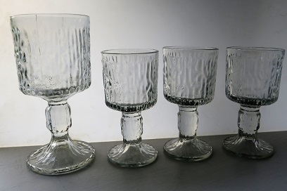 A collection of four retro Ravenhead glasses.