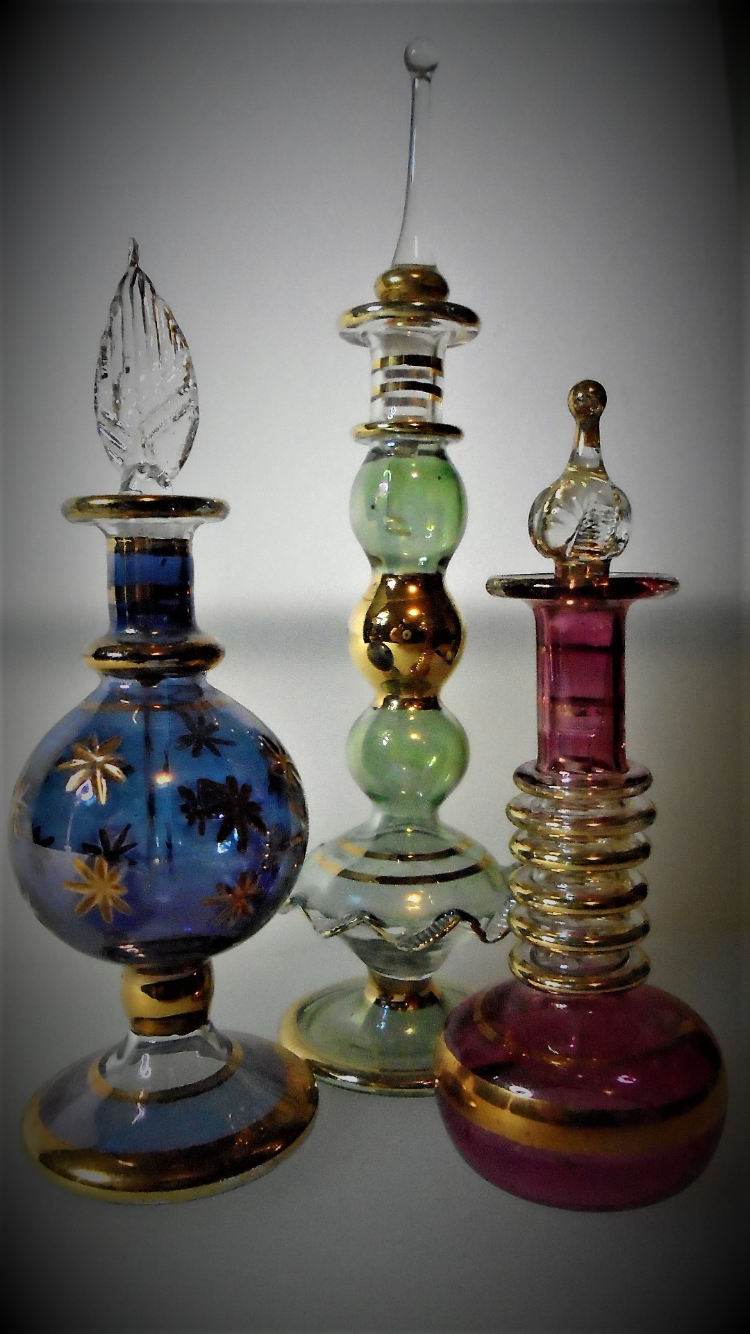  3 pretty Egyptian glass perfume bottles.