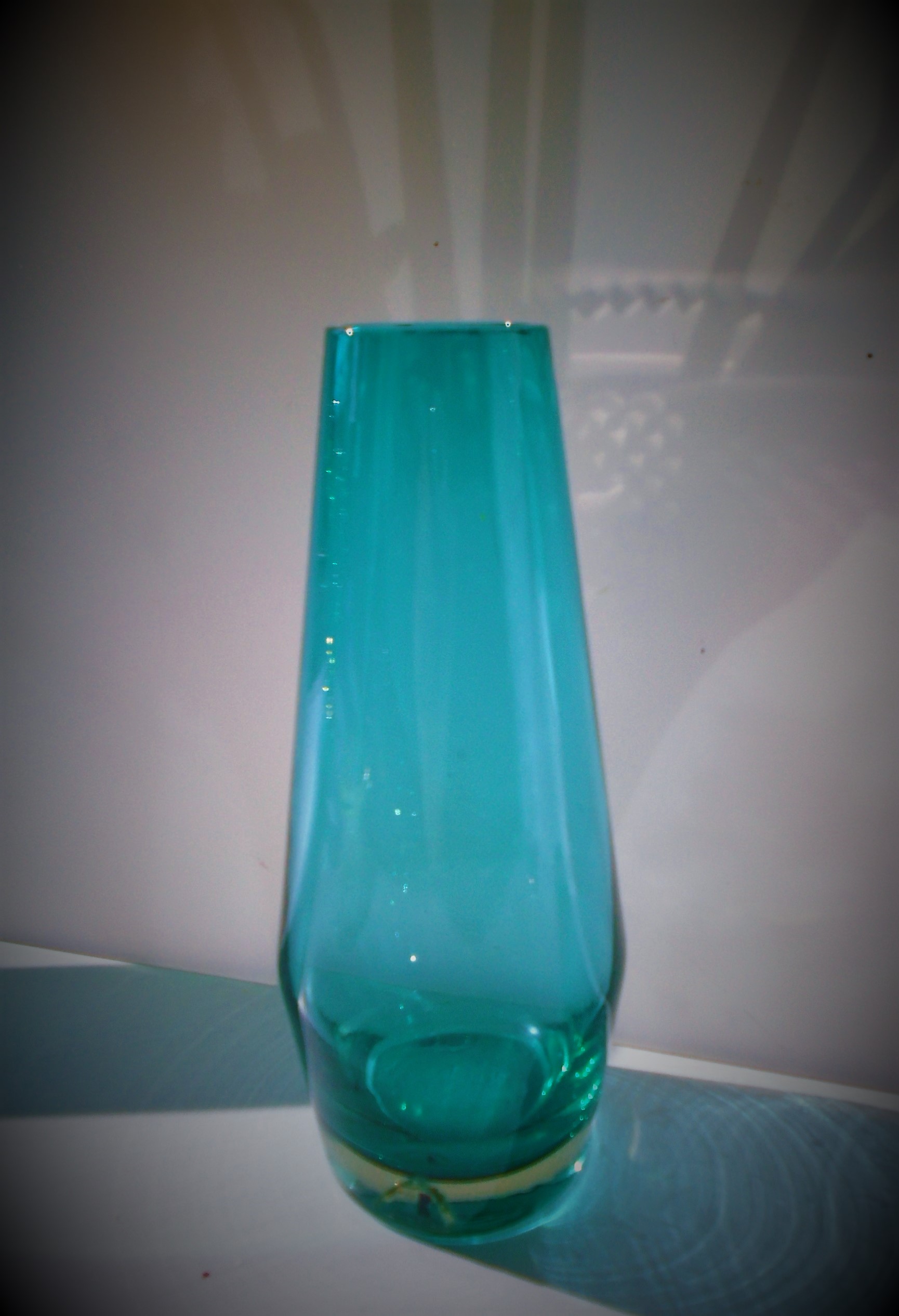 Offered for sale is a fine example of a vintage Tamara Aladin designed Riihimaki aqua coloured glass vase.