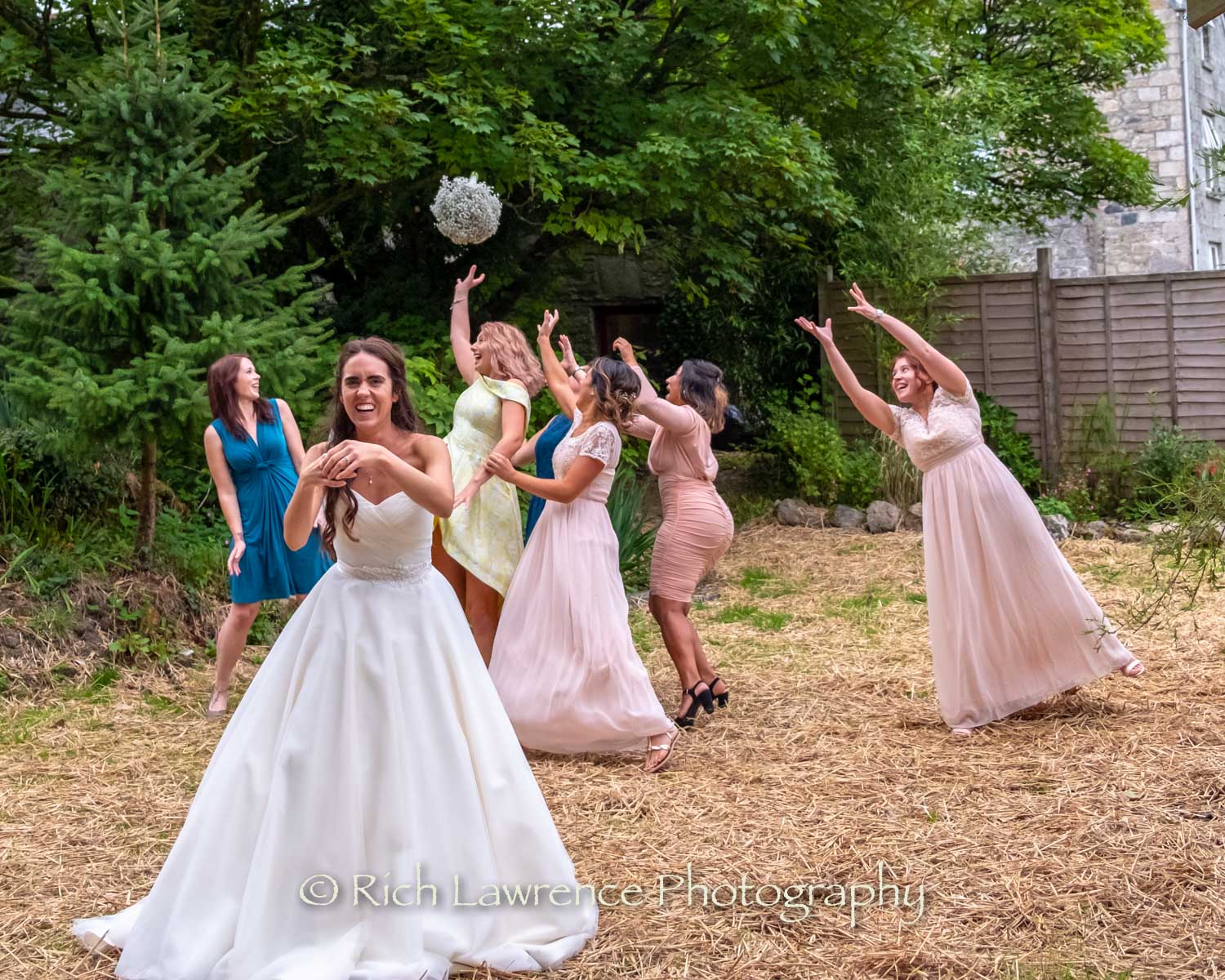 bride throwing bouquet